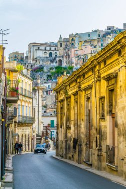 View of a narrow street in Ragusa, Sicily, Ital clipart