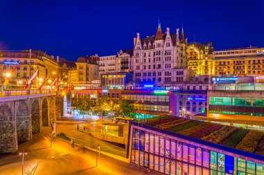 LAUSANNE,  SWITZERLAND, JULY 18, 2017: Night view of the Flon square in Lausanne, Switzerlan clipart