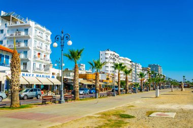 LARNACA, CYPRUS, AUGUST 16, 2017: People are enjoying a sunny day on Finikoudes promenade in Larnaca, Cypru clipart