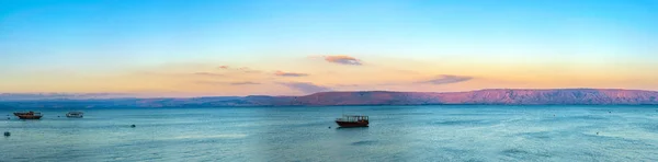 Vista sul tramonto di una barca di legno galleggiante sul mare di Galilee, Israele — Foto Stock