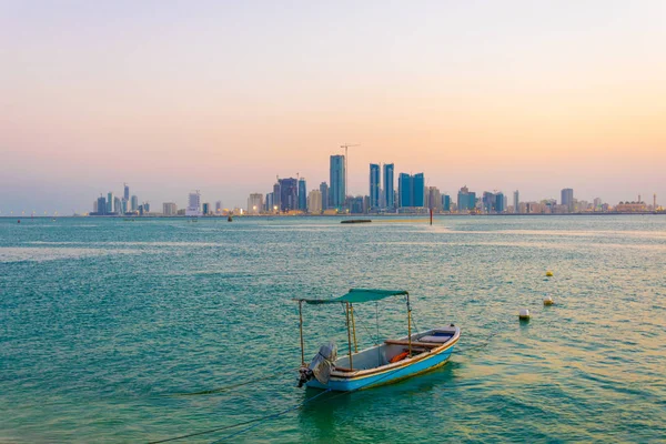Ο ορίζοντας της Μανάμα με ένα σκάφος κατά τη διάρκεια του ηλιοβασιλέματος, Μπαχρέιν. — Φωτογραφία Αρχείου