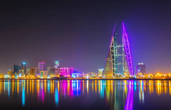 Skyline of Manama dominated by the World trade Center building during night, Bahrain.