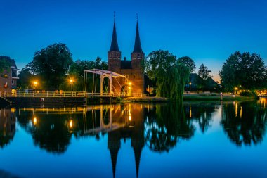 Hollanda'nın Delft şehrine giden Oostpoort kapısının gün batımı manzarası, N