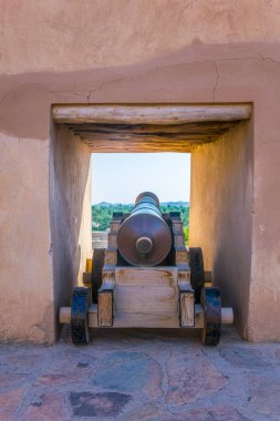 View of a cannon ready to fire at the nizwa fortress in Oman. clipart