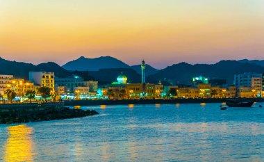 View of coastline of Muttrah district of Muscat during sunset, Oman. clipart