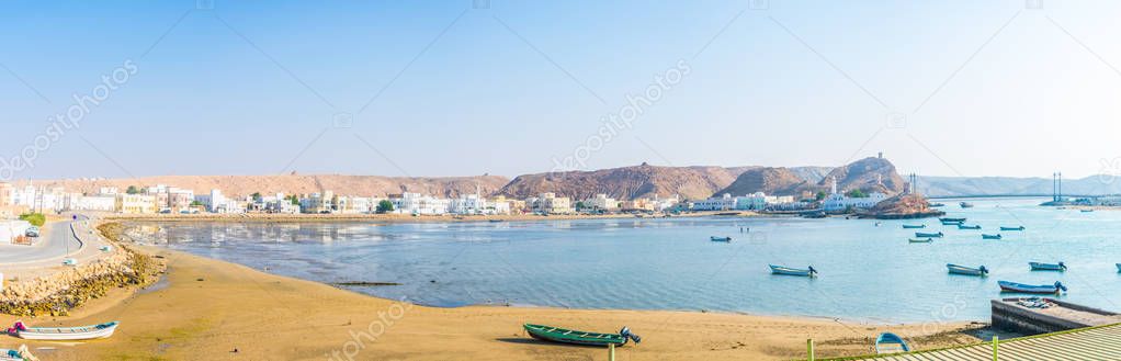 View of fishing boats anchoring in a bay in the Omani town Al Ayjah.