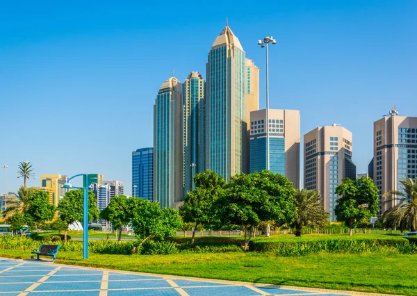 View of a corniche in Abu Dhabi stretching alongside the business center full of high skyscrapers. — Stock Photo, Image