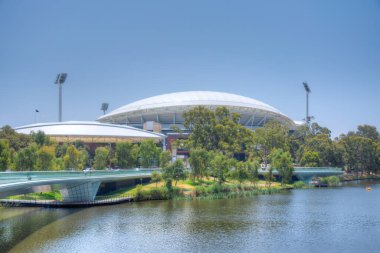 Adelaide oval viewed behind torrens river in Australia clipart