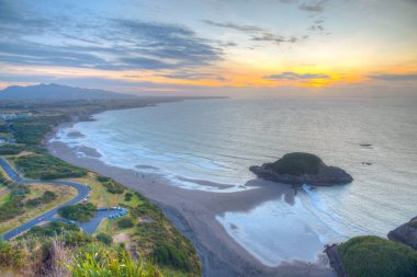 Sunset aerial view of coast of New Zealand from Paritutu rock near New Plymouth clipart