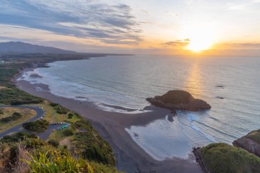 Sunset aerial view of coast of New Zealand from Paritutu rock near New Plymouth clipart