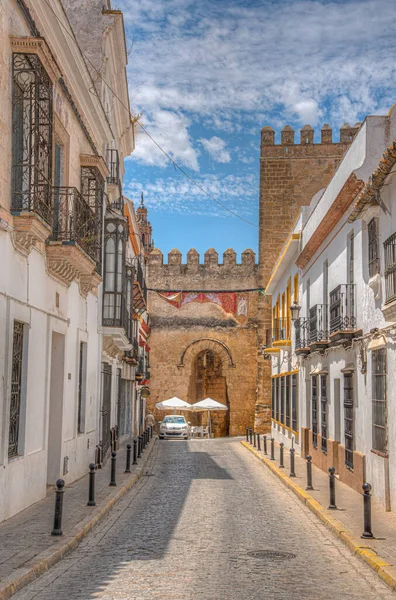 White street of Spanish town Carmona and Alcazar fortress