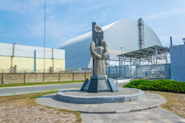 Containment area of Chernobyl power plant viewed behind a memorial in the Ukraine