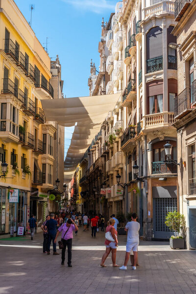 MURCIA, SPAIN, JUNE 19, 2019: People are strolling on a street in Murcia, Spain