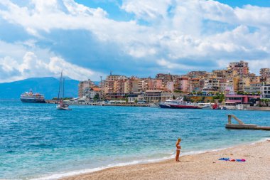 SARANDE, ALBANIA, 26 Eylül 2019: İnsanlar Arnavutluk 'un Sarande kentindeki bir plajda güneşli bir günün tadını çıkarıyorlar
