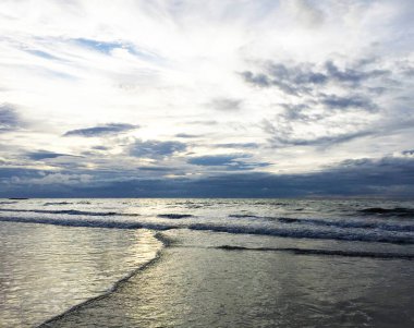 Okyanusta gün batımı ve dalgalar.