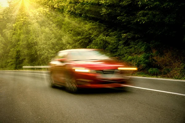 The car on the road at full speed, blur
