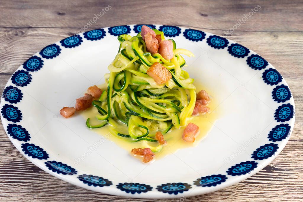 Zucchini alla carbonara.A twist on the traditional Italian carbonara using zucchini noodles instead of spaghetti and omitting the cream for a gluten free, low carb version of the dish.