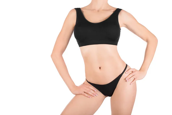 Žena oříznuté fit tělo v černé základní spodní prádlo, izolované na bílém. — Stock fotografie