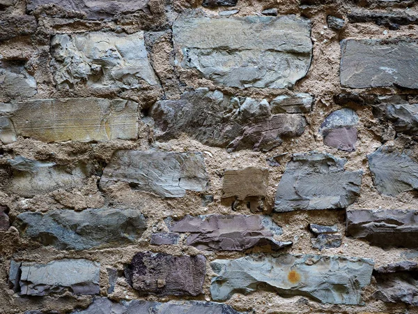 Muro di pietra di una vecchia casa di rocce, vecchia muratura. Texture, lavori in pietra — Foto Stock