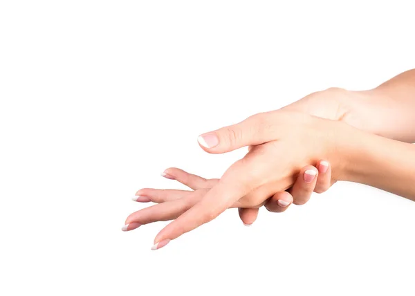 Kobiecych rąk z francuski manicure klasyczny. Kobieta pociera jej ręce, białe tło, zbliżenie. Zadbana skóra — Zdjęcie stockowe