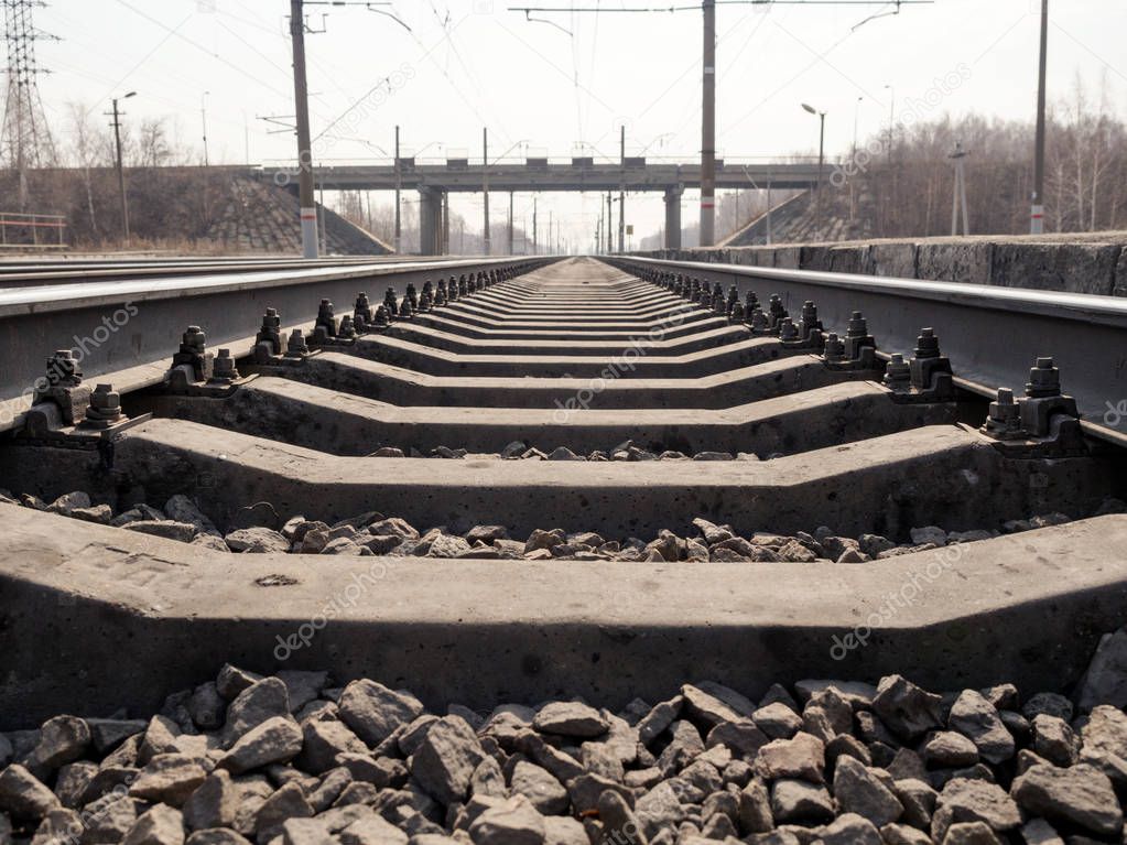 Empty railway line, rails, sleepers, rubble close up, wide angle, toned brown, selective focus