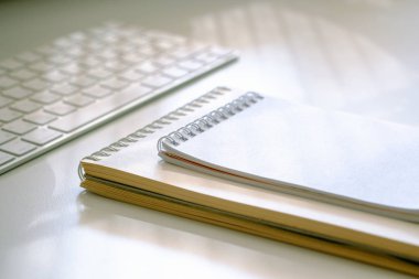 Two opened notebooks and a keyboard  are on the table clipart