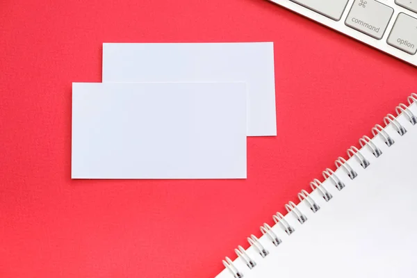 Top view with copy space of an office table with business objects for a work; red background