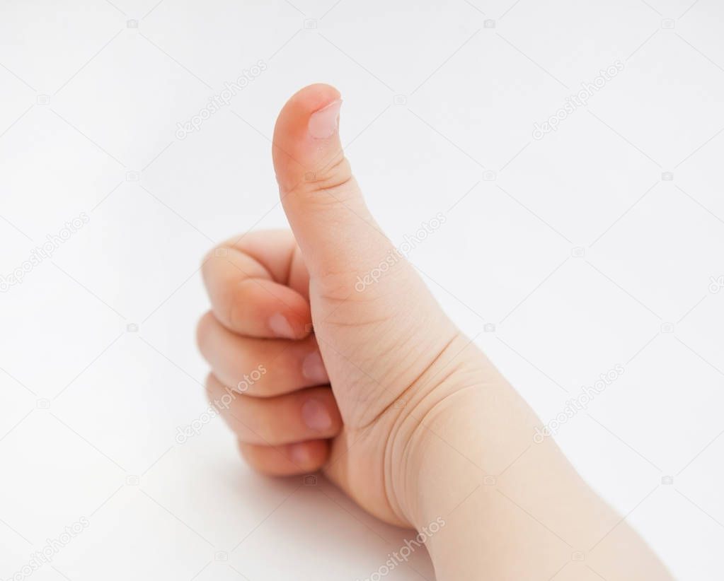 Child's hand showing positive sign, white background