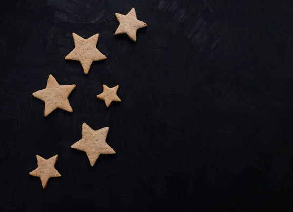 Cookies in a shape of stars on a black background