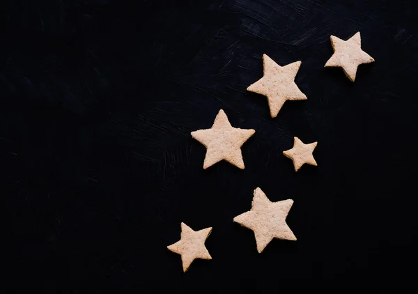 Cookies in a shape of stars on a black background