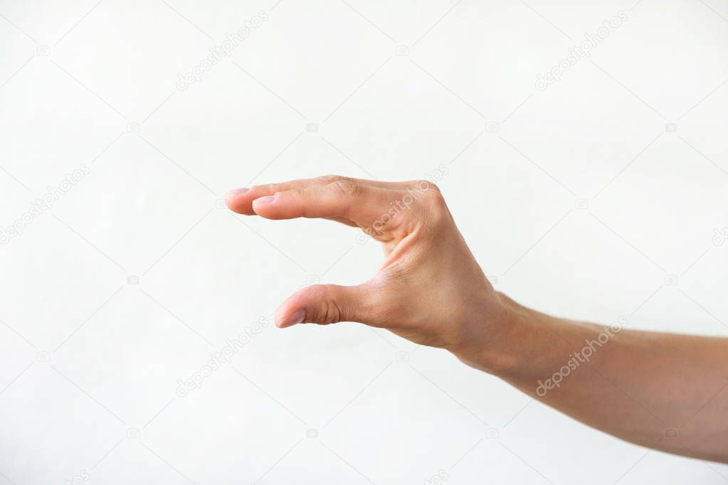 Female hand shows some distance /size, white background