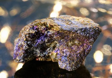 Stone chalcopyrite on a beautiful glowing background clipart