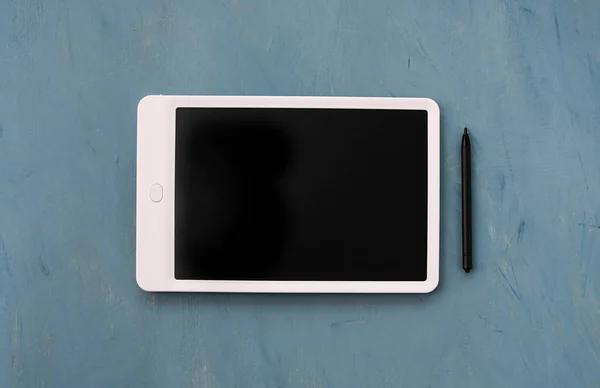A tablet with an emty black monitor on a blue background