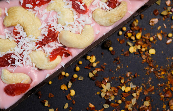 Pieces of sweet pizza on a black background strewn with paprika