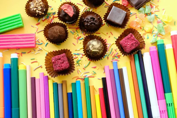 Composition of colored pencils and beautiful sweets — Stock Photo, Image