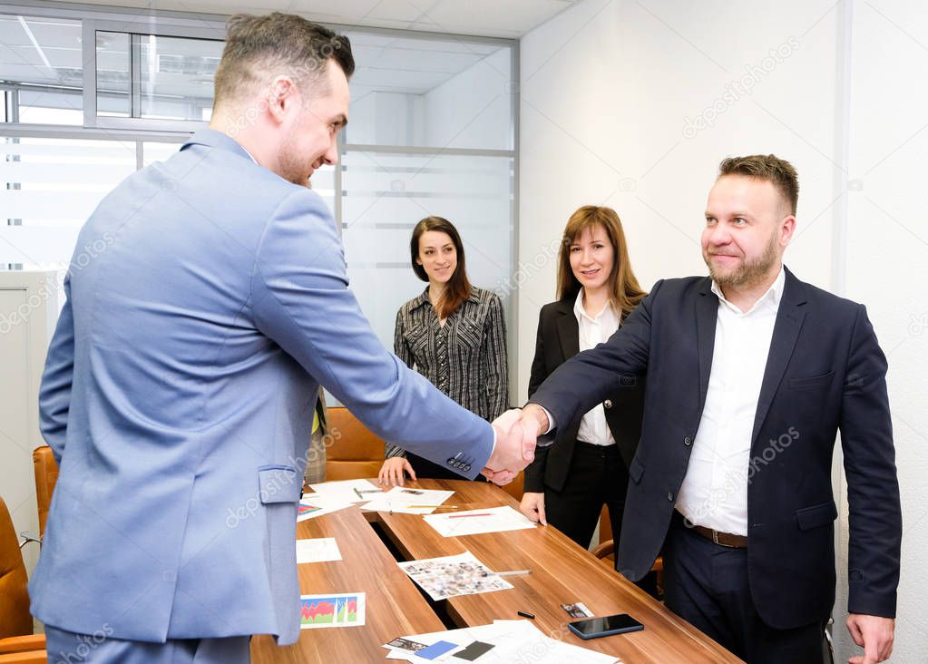 Businessmen shake hands each other