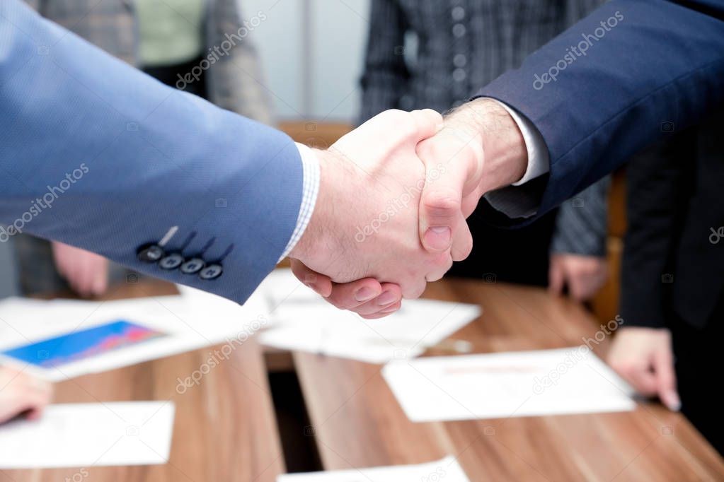 Businessmen shake hands each other