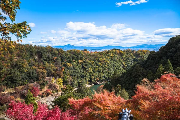 colorful of maple forest on the mountain at autumn season in Arashiyama, Kyoto, Japan. From observation view point at Senkoji temple, over hozu river.