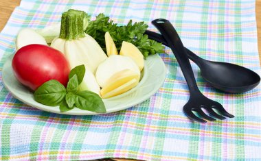 Taze sebze: kemik iliği, domates, soğan, patates, fesleğen, maydanoz, masada kareli kumaş üzerine tabakta düzenlenmiş kesme. Vegan gıda, vejetaryen ve sağlıklı beslenme kavramı