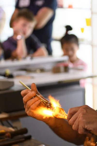 Children are interested in watching the work of the master glassblower