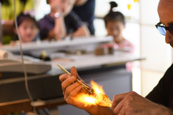 Children are interested in watching the work of the master glassblower