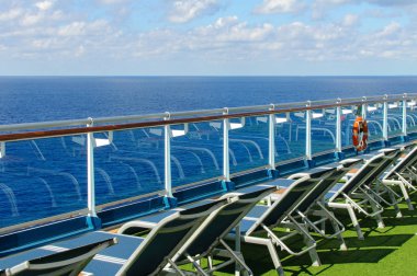 Okyanusta bir yolcu gemisinin güvertesinden görünümü. Yolcular, sandalyeler ve şezlonglar için oturma alanı. Güneşlenmek.