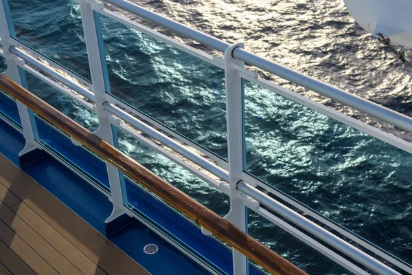 View from the deck of the cruise ship to the ocean. Sea horizon, clouds, blue tropical sky