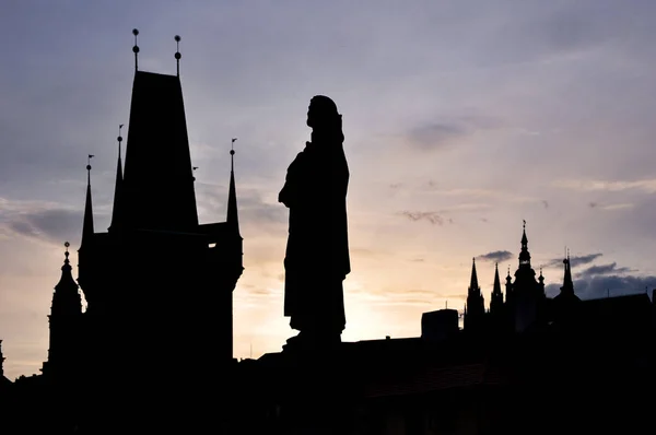 Prag, Çek - Mayıs 2009: Eski kentin kulelerine karşı Charles köprüsü üzerinde tarihi bir heykel silueti