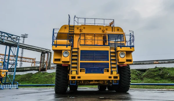 View of the parking lot of an exhibition of large career heavy dump trucks at the automobile plant Belaz in the Republic of Belarus. Zhodino .