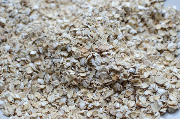 Oat flakes. Pattern of oat flakes. Hercules as background