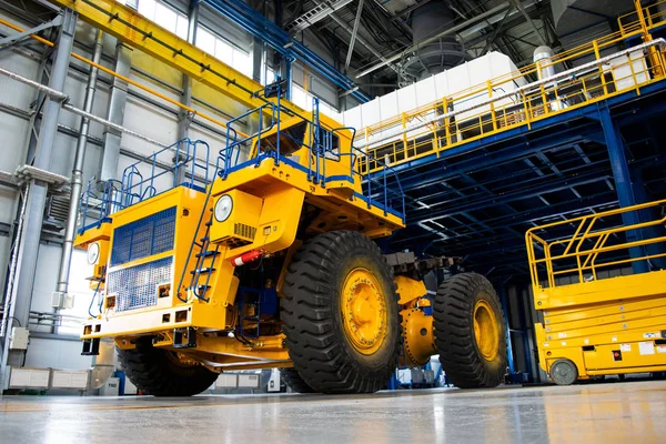 Big mining truck in the production shop of the car factory. Belaz is a Belarusian manufacturer of haulage and earthmoving equipment, dump trucks, haul trucks, heavy equipment.