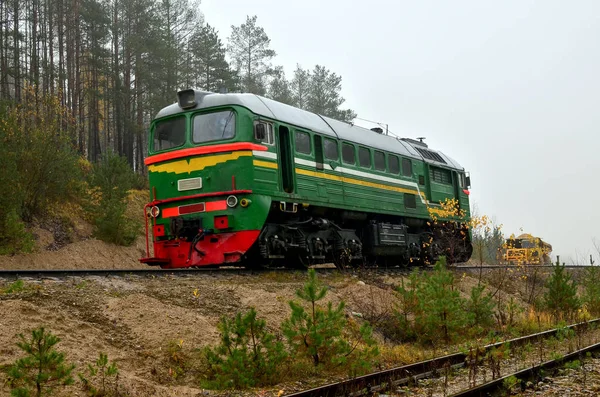 Freight train in a sand pit in cloudy foggy weather. Logistics of cargo delivery by rail