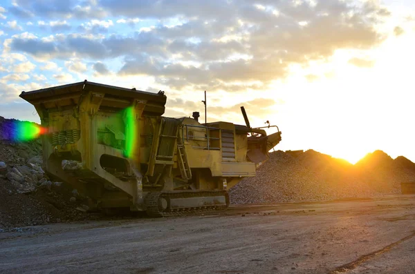 Mobile Stone crusher machine by the construction site or mining quarry for crushing old concrete slabs into gravel and subsequent cement production