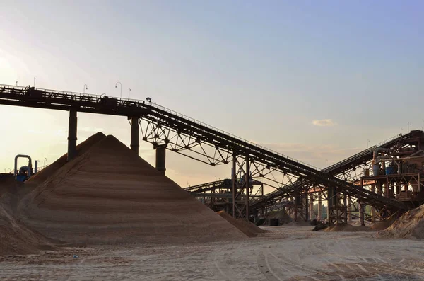 Sand Making Plant in mining quarry. Crushing factory, machines and equipment for crushing, grinding stone, sorting sand and bulk materials.